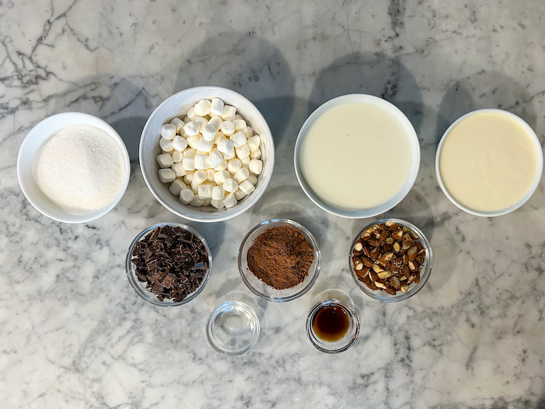 Ingredients for making homemade ice cream, arranged on a marble surface