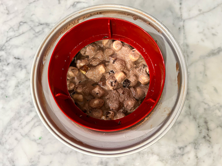 Rocky road ice cream in an ice cream maker after churning