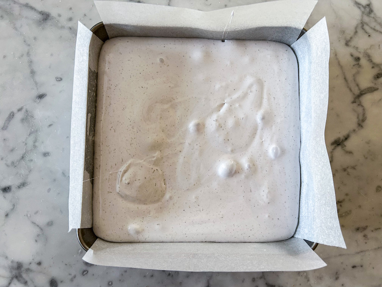 Lavender marshmallows cooling in a square metal tin