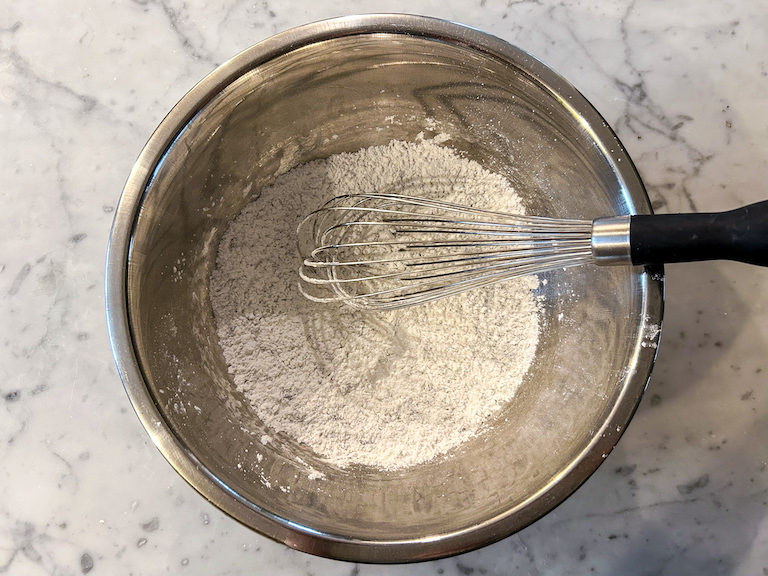 Marshmallow coating in a bowl with a whisk