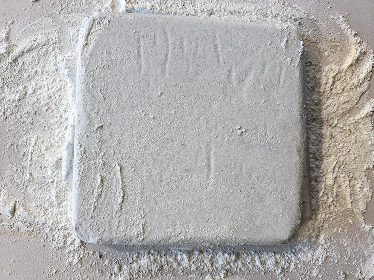 A slab of lavender marshmallows on a cutting board