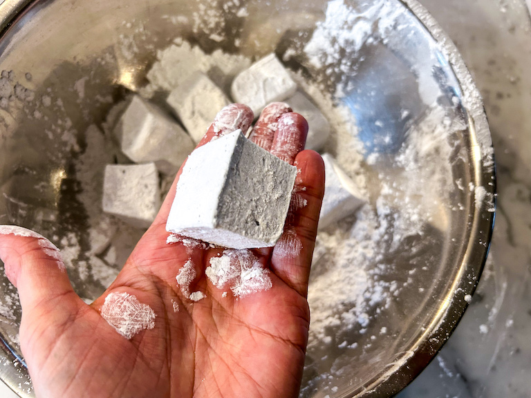 Hand holding a powdery homemade marshmallow