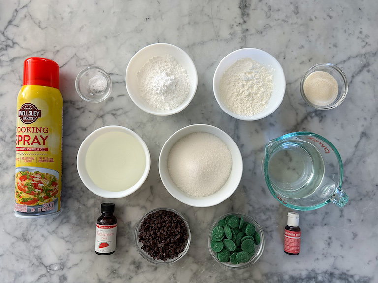 Watermelon marshmallow ingredients arranged on a marble surface