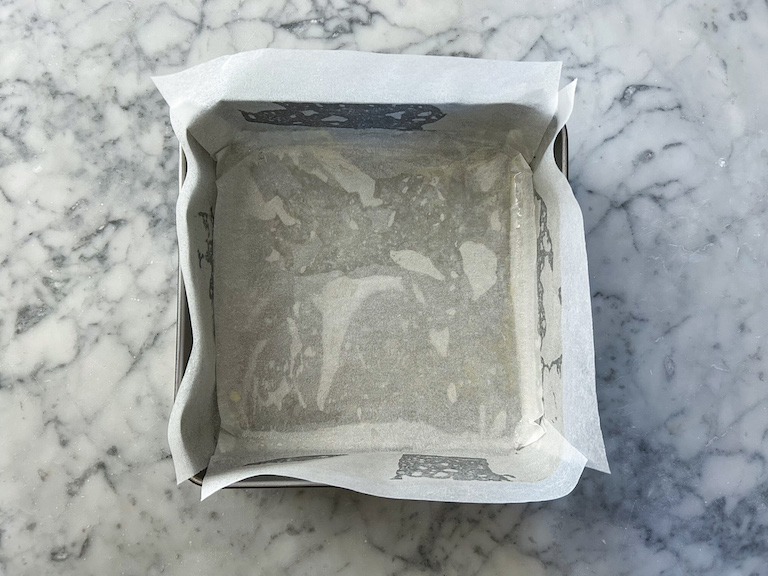 A square tin lined with parchment