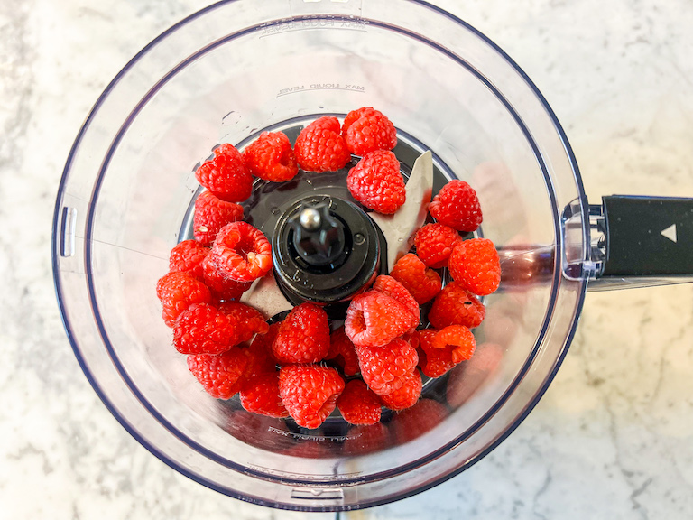 Fresh raspberries in a food processor