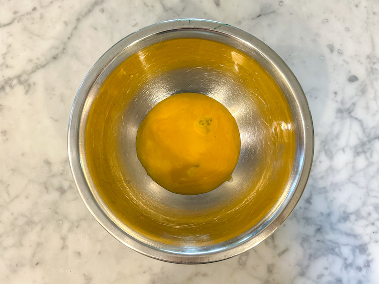 Egg yolks in a metal bowl