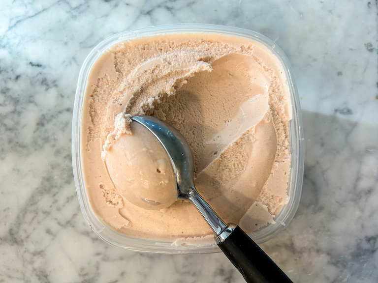 Ice cream scoop scooping homemade raspberry white chocolate ice cream