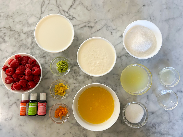 Rainbow sherbet ingredients arranged on a marble surface