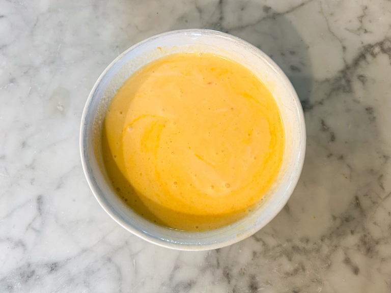 Orange sherbet base in a small bowl