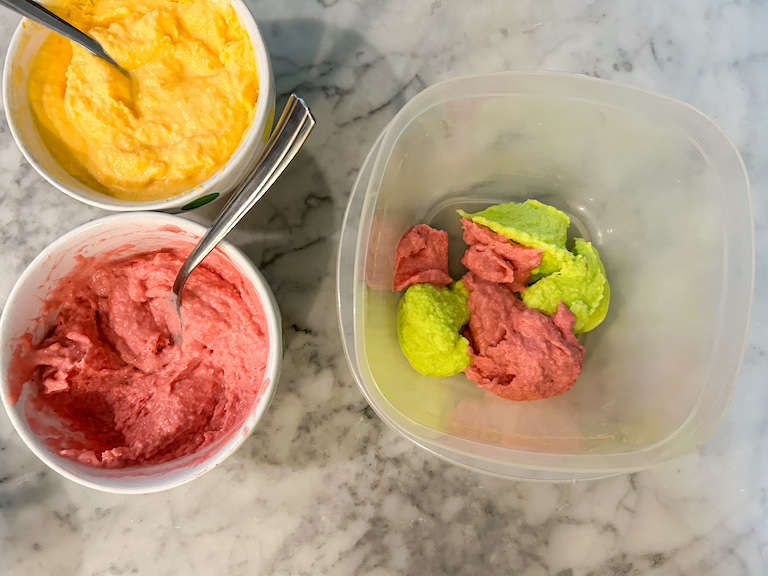 Layering rainbow sherbet into a plastic container