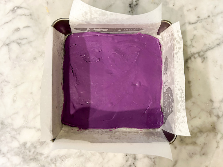 A pan of purple fudge on a marble surface
