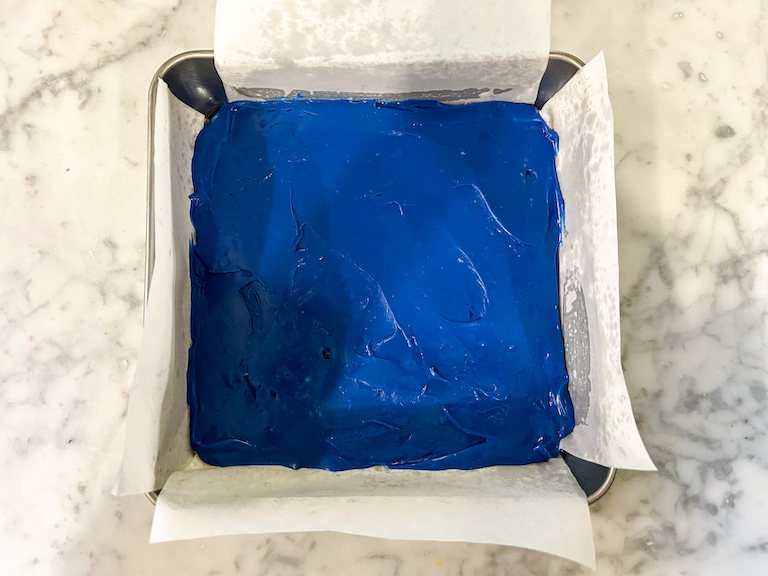 Blue fudge in a parchment lined tin