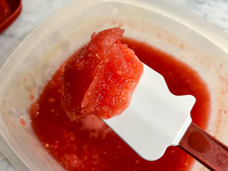 Spatula with a scoop of half-frozen watermelon granita