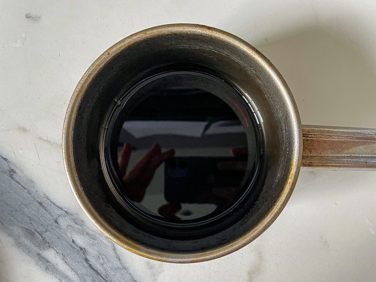 A small pan of cola on a marble surface