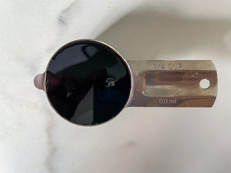 A measuring cup of reduced cola