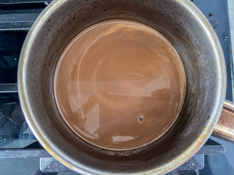 Warming cream and cola in a small pan on the stovetop