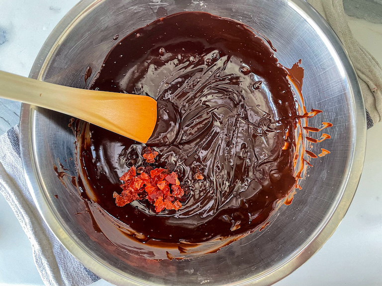 Stirring chopped cherries into chocolate ganache