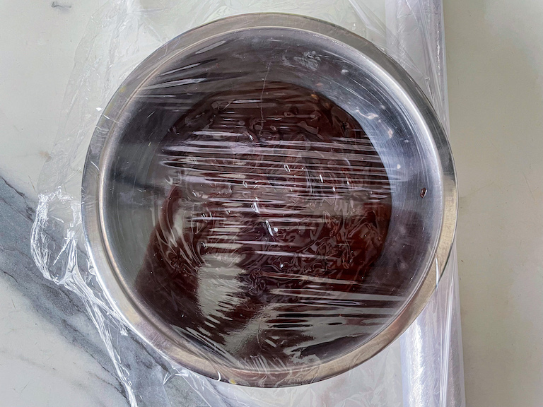 a bowl of ganache covered with plastic wrap
