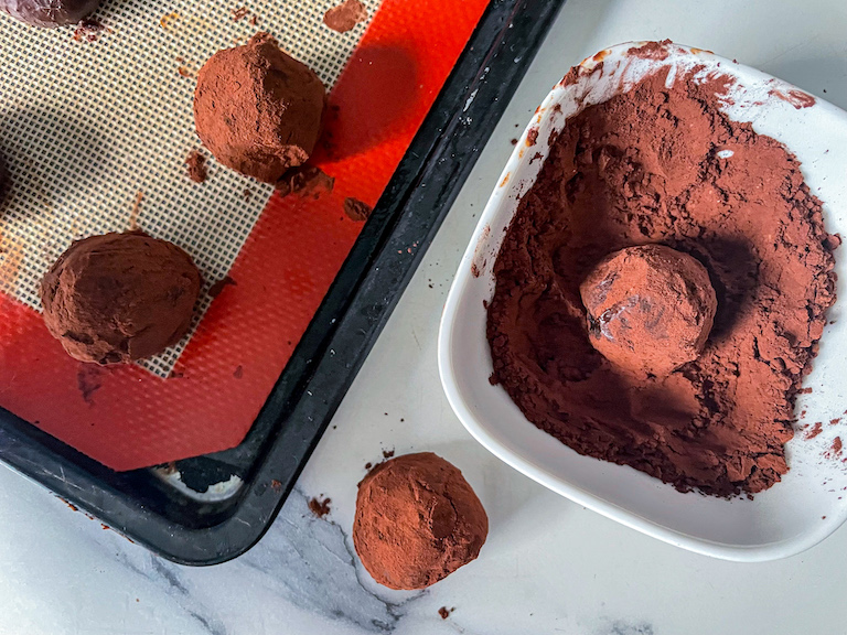 Rolling truffles in cocoa powder