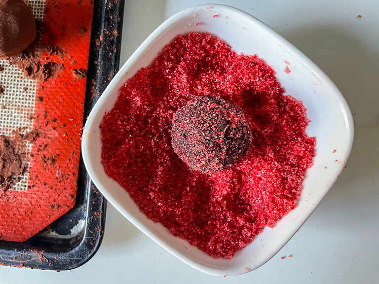 Rolling a chocolate truffle in red sugar