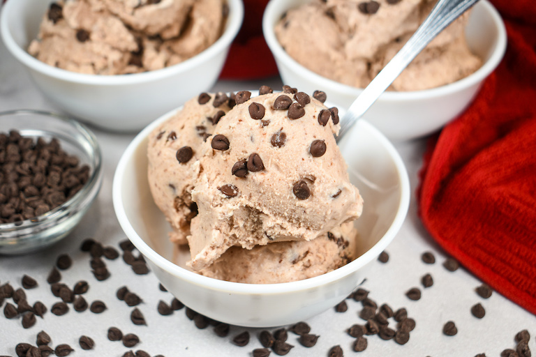 Horizontal shot of a dish of chocolate cherry ice cream garnished with miniature chocolate chips