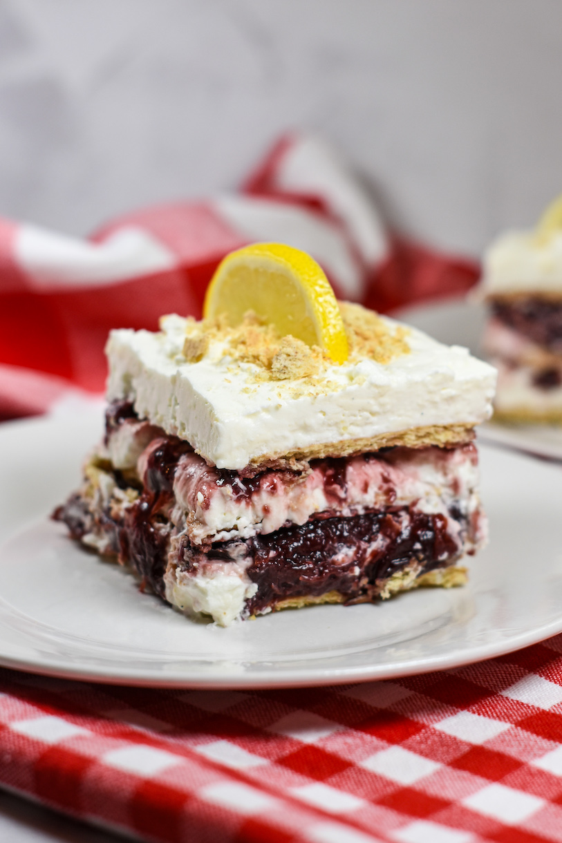 a slice of cherry cheesecake icebox cake on a plate