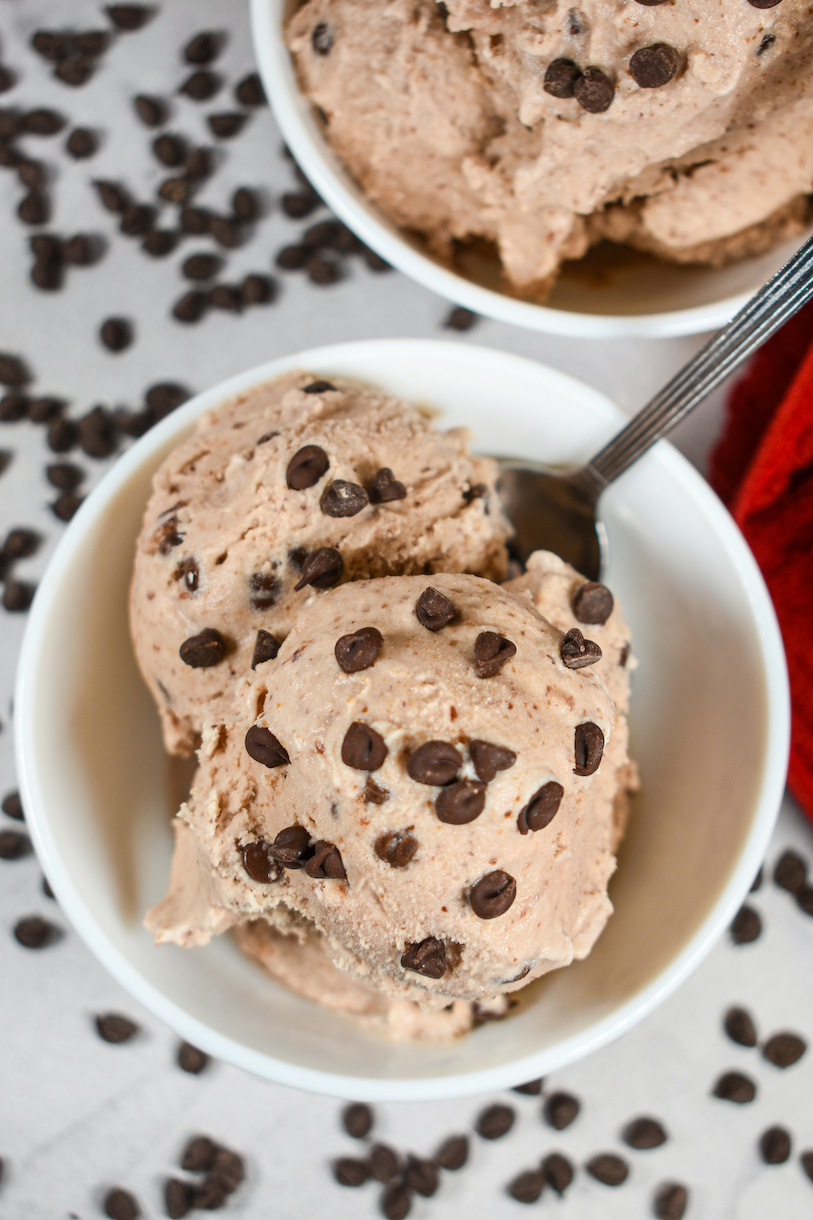 Looking down at a dish of homemade cherry ice cream garnished with chocolate chips