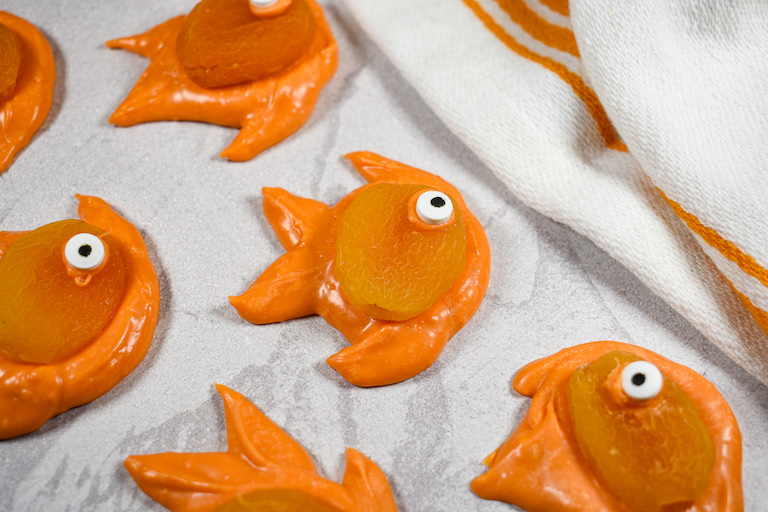 Chocolate apricot goldfish arranged on a white surface