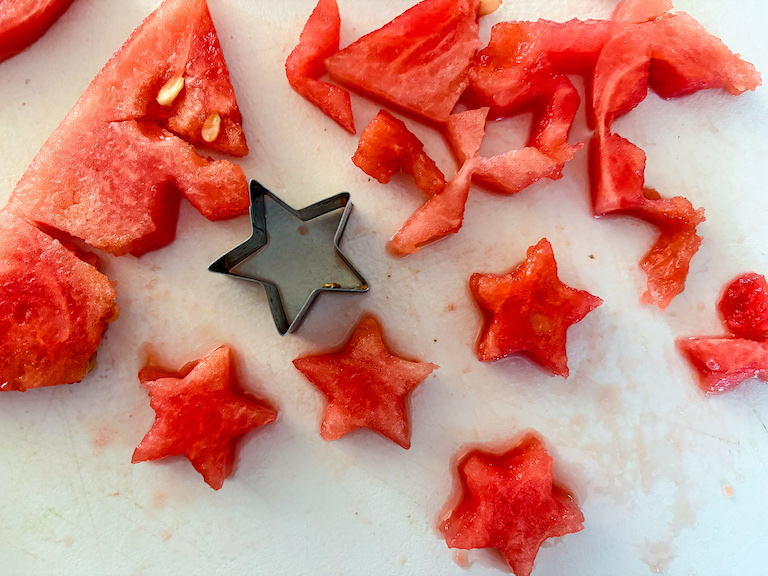 A star shaped metal cutter cutting watermelon