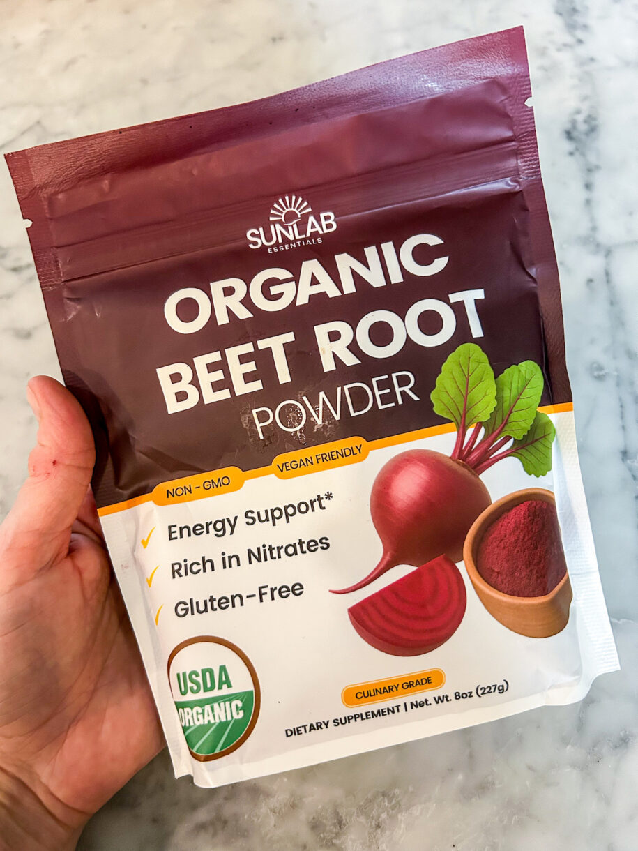 Hand holding a bag of powdered beets