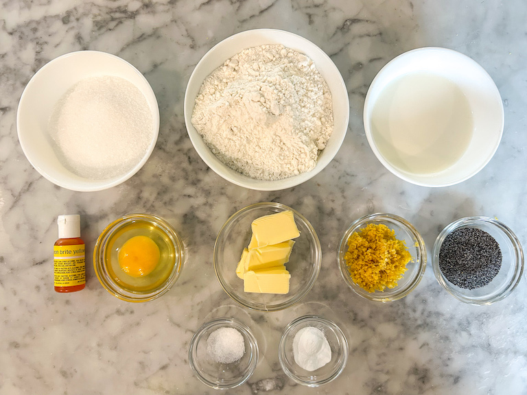 Lemon poppyseed whoopie pie recipe ingredients arranged on a marble surface