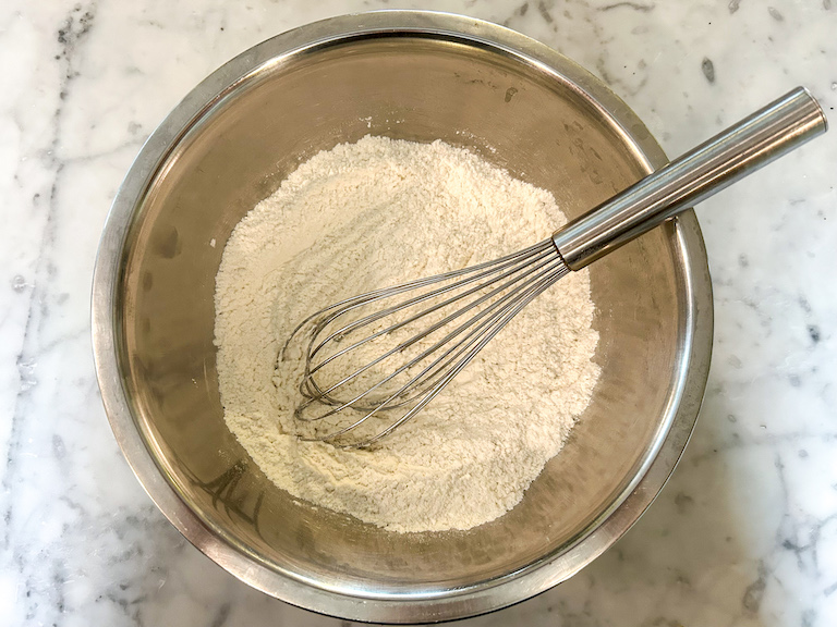 Dry ingredients in a mixing bowl with a whisk