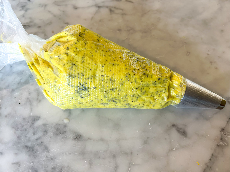A piping bag of lemon poppyseed whoopie pie batter