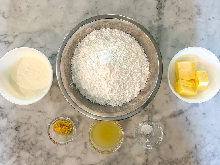 Lemon buttercream ingredients arranged on a marble surface
