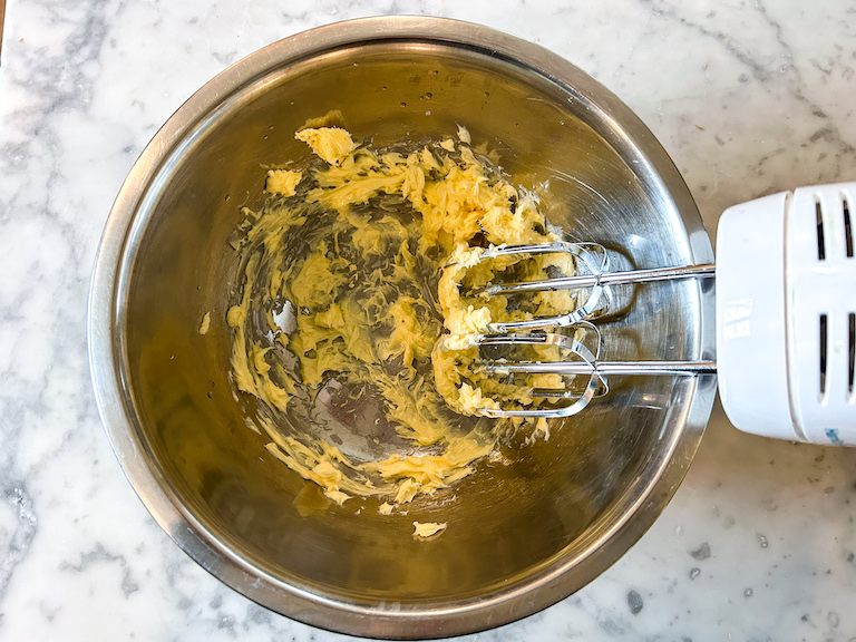 Whipped butter in a bowl with a hand mixer