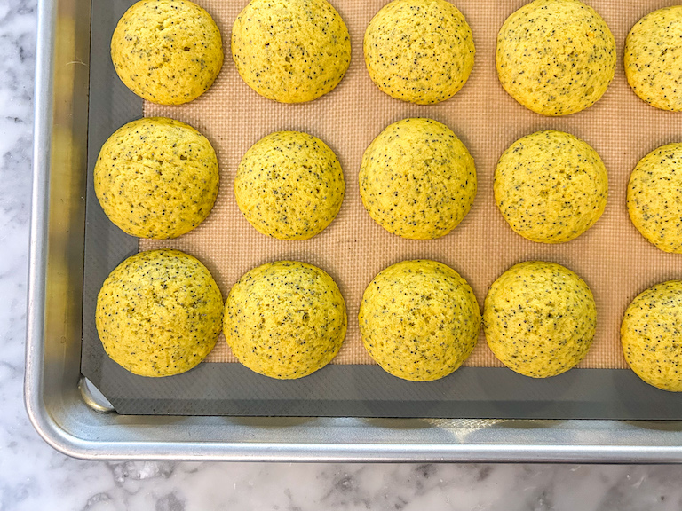 Lemon poppyseed whoopie pie cakes on a baking tray