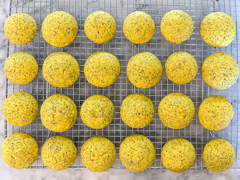Lemon whoopie pie cakes arranged on a wire cooling rack