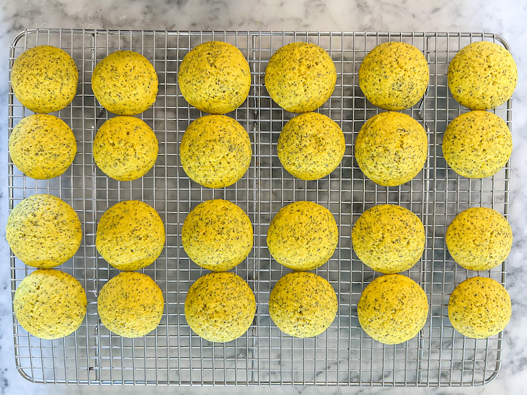 Yellow lemon whoopie pie cakes arranged on a wire rack