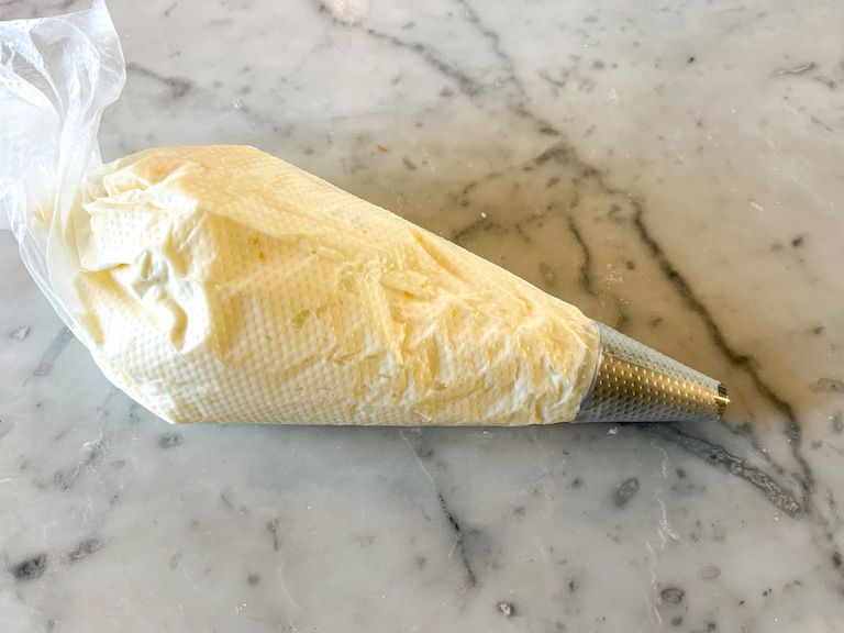 A piping bag of lemon buttercream