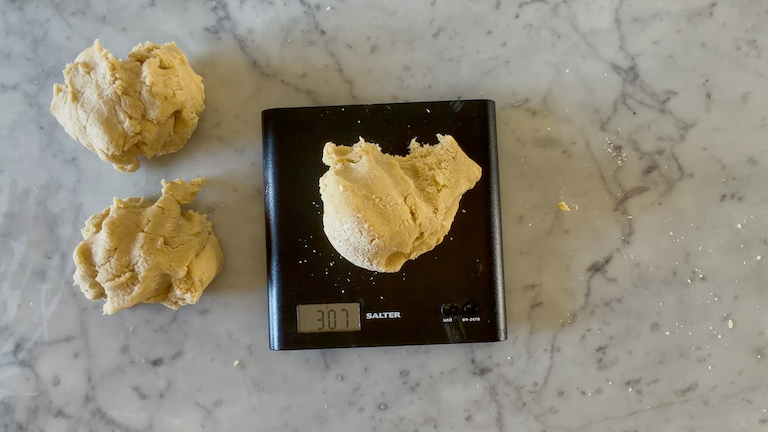 Weighing cookie dough on a kitchen scale