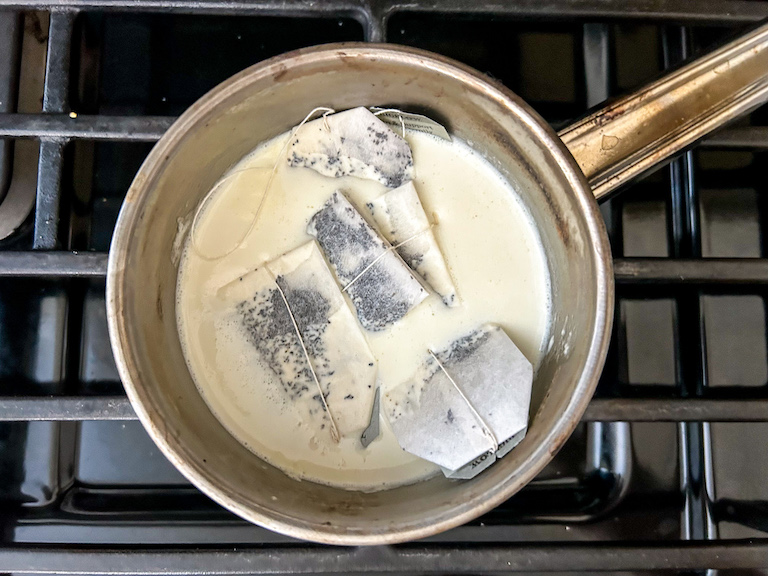 Earl Grey tea bags and cream in a small pan on the stovetop