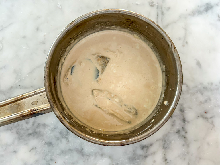 Earl Grey tea bags soaking in a pan of cream