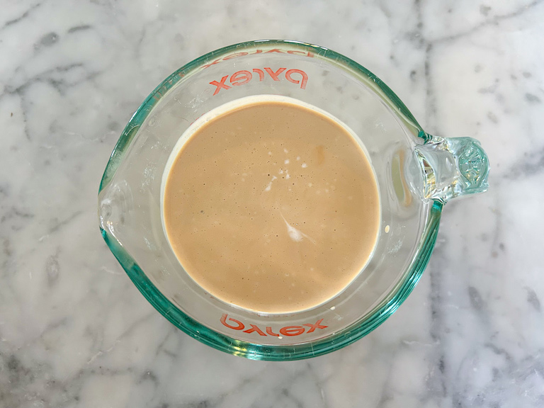 Measuring cup of Earl Grey infused cream