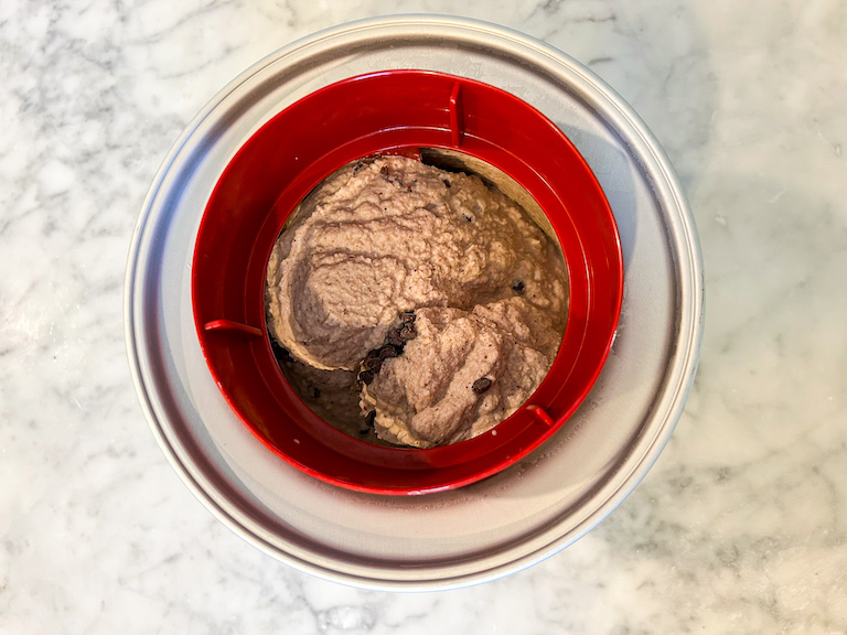 Cherry ice cream in an ice cream maker after churning