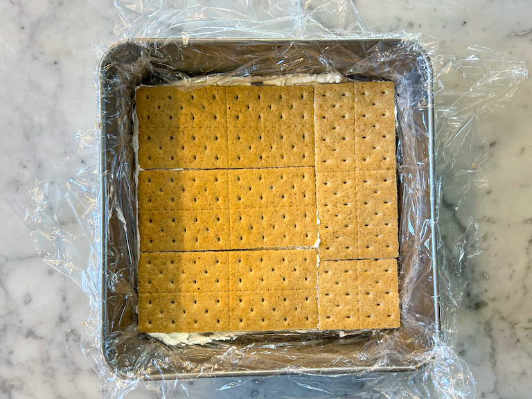 Graham crackers arranged in a square metal tin