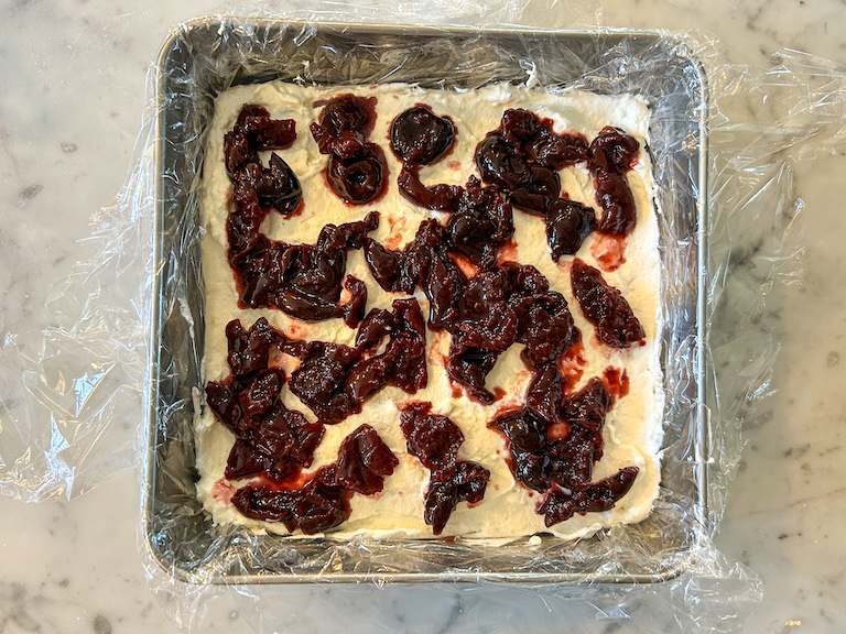 Cherry compote layered over cheesecake filling