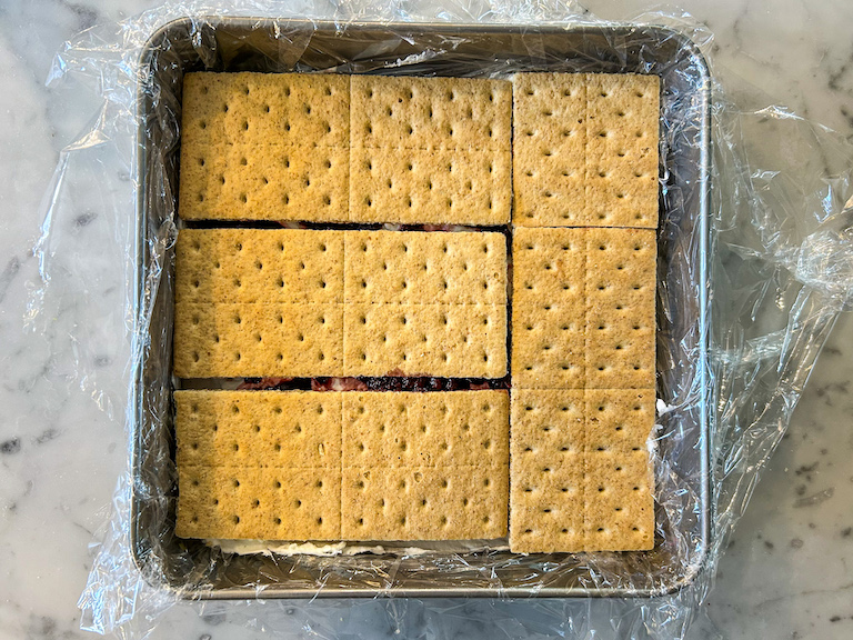 Graham crackers arranged in a square metal tin