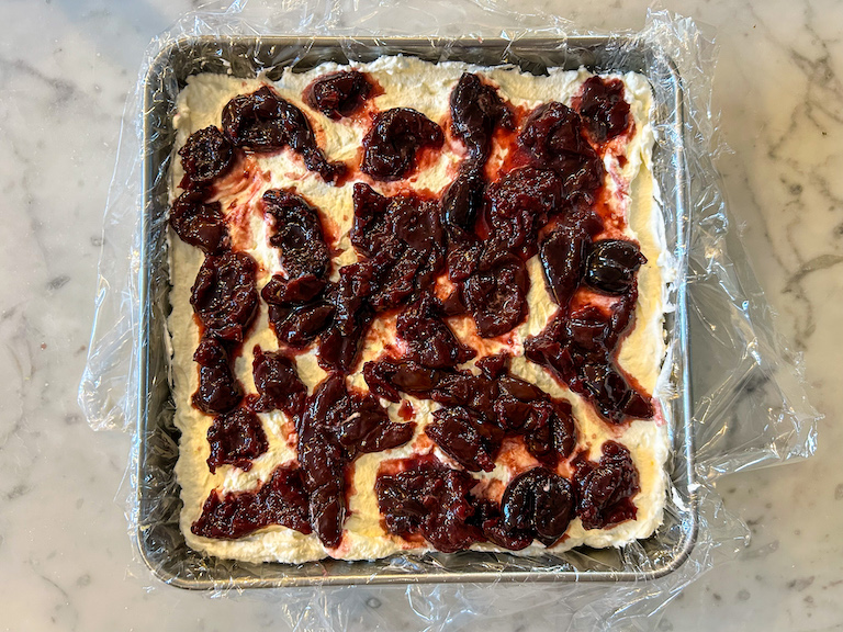 Cherry compote layered on top of cheesecake filling