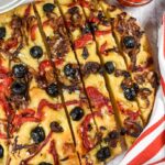 A sliced loaf of caramelized onion focaccia