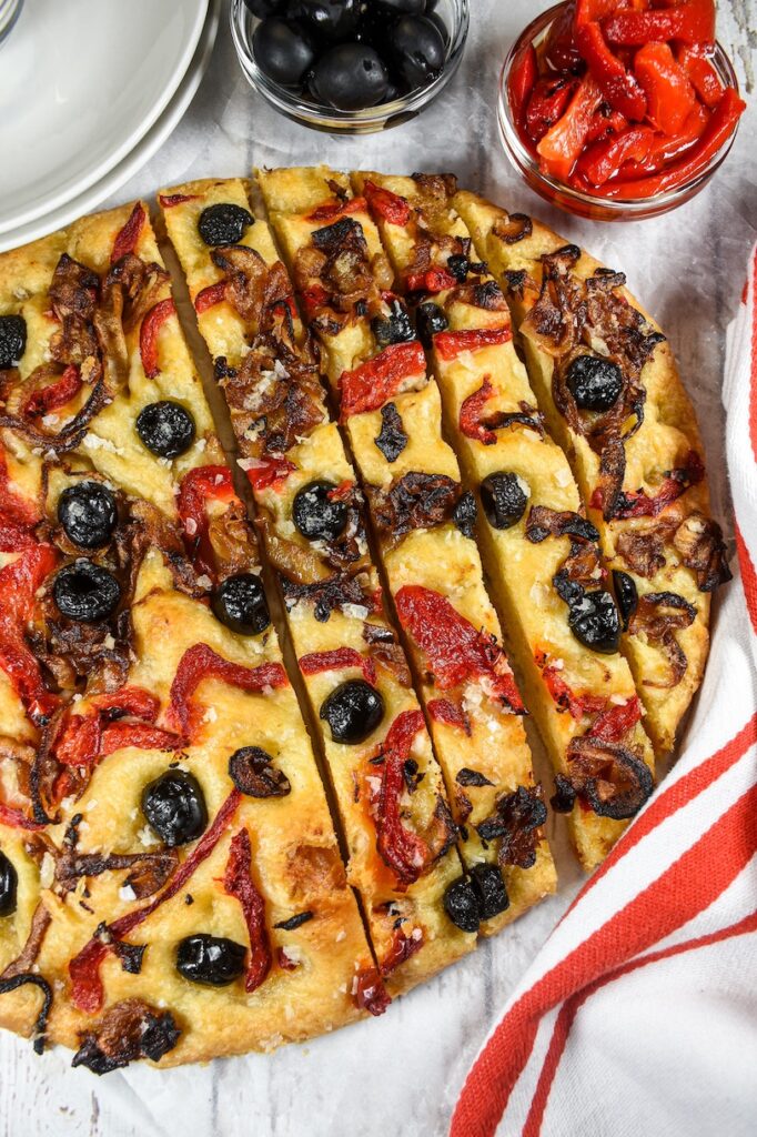 A sliced loaf of caramelized onion focaccia